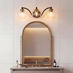 <p>3-Light Vanity with Sleek Metal Frame and Clear Glass Globe Shades</p>